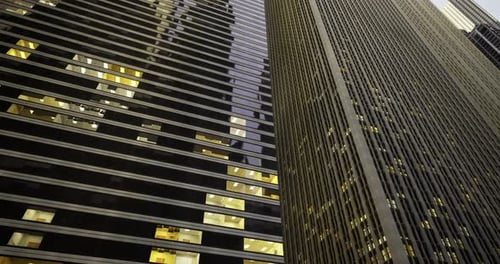 Skyscrapers with Illuminated Windows in Urban Environment at Dusk