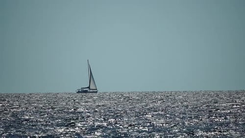 Sailing Ship Luxury Yacht with White Sails in the Sea in the Evening Sunlight