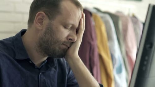 Tired Man with Beard Sleeping at Office Desk