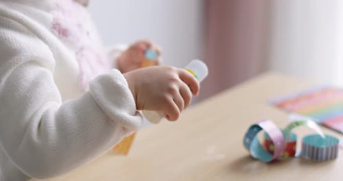 Child with Mother Preparing for Christmas Cutting Out Paper Garlands