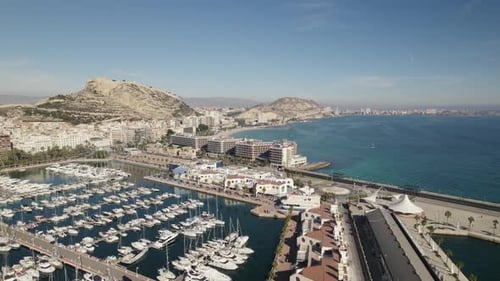 Yachts moored in marina of Alicante historic port city, Costa Blanca; aerial