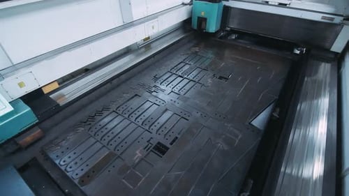 Metal Plates Fed Into Machine for Metalworking. Metallic Equipment in Factory. Industrial