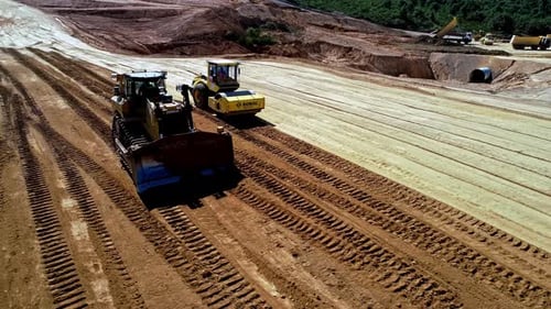 Aerial View of Heavy Machinery Working on a Large Construction Site