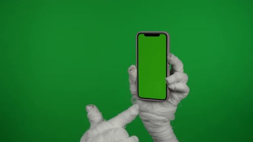Detail Green Screen Isolated Chroma Key Video Capturing Mummy's Hand Holding a Smartphone with an