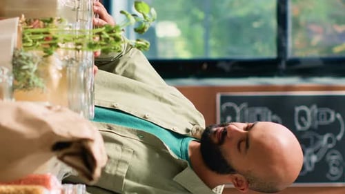 Smiling Man Posing with Organic Food and Herbs