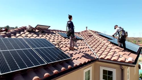 Solar Panels Installation Project, Aerial View of Installers on House Rooftop Revealing Residential