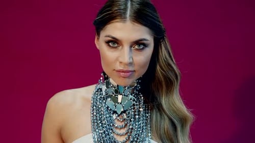 Portrait of Sexy Woman with Fashion Makeup and Hairstyle in Studio with Red Purple Background