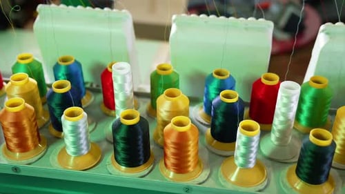 Collection of colorful spools for a dressmaker. Sewing tools for handicraft job.