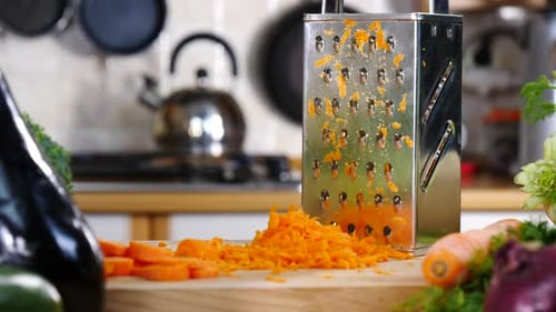 Preparing Shredded Carrots in a Bright Kitchen