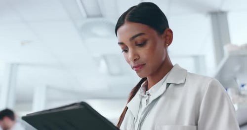 Woman Reviews Tablet in Bright Lab