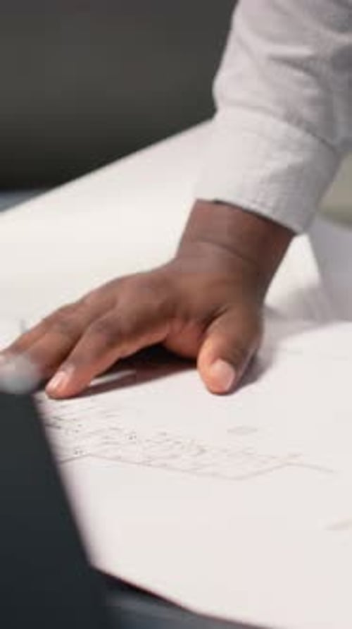 Vertical Video African American Contractor Examine Architectural Blueprints Plans on Table
