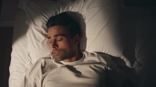 Tired Man Resting Pillow in Dark Bedroom Closeup Top View Sleepless Guy Tossing
