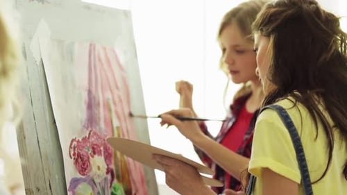 Art School, Creativity And People Concept - Group Of Students With Easels And Palettes Painting S...