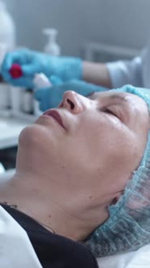 Woman Receiving Facial Treatment in Spa