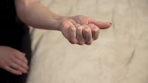 Close Up Woman Clenches and Unclenches Fingers on Hand Female Flexes and Releases Fingers Exercising