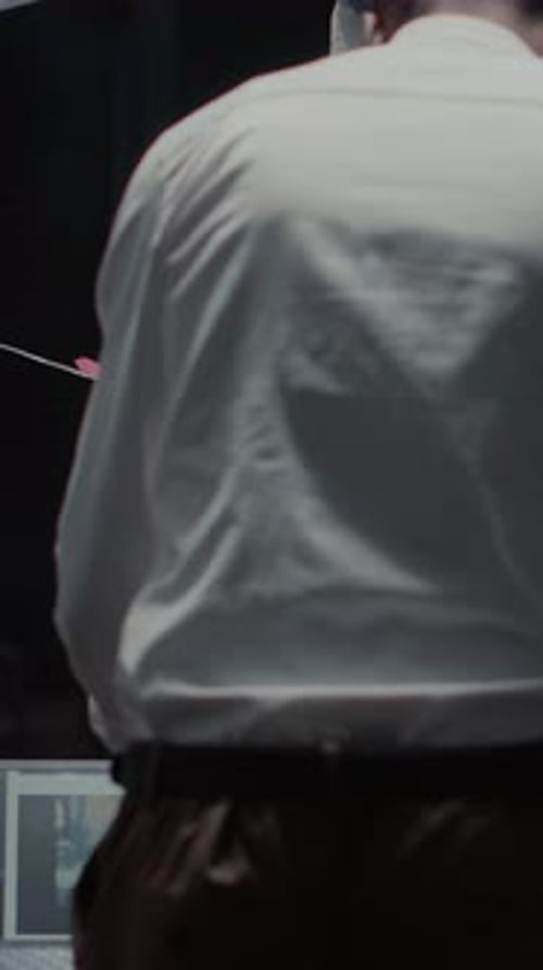 Man Investigating Evidence on Bulletin Board