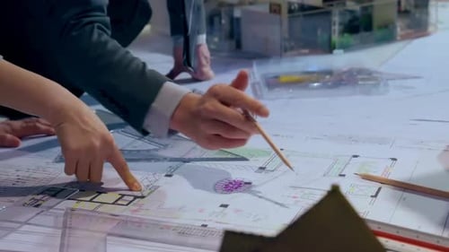 Architect team brainstorming idea and planning building design about house project while sitting at