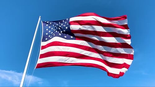 American Flag Waving Against Clear Blue Sky