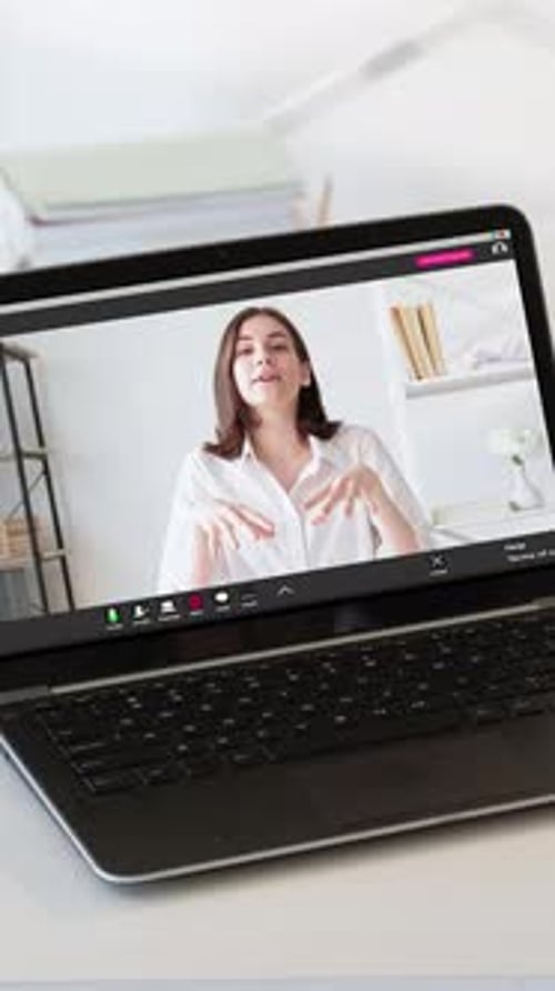 Woman Talking During Virtual Conference Call on Laptop