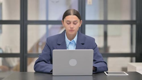 Woman Works at Desk with Laptop and Tablet