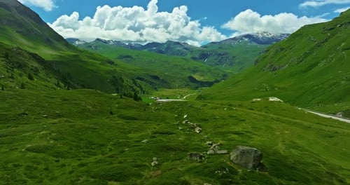 Drone Flies Over Green Picturesque Valley with Mountains in the Background High Mountains Famous