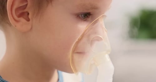 Sick Boy Inhaling Medication with Nebulizer Mask