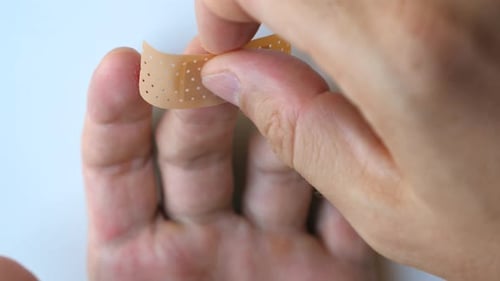 Applying Bandage to Finger Injury Close Up