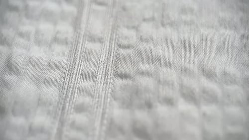 Detailed Close-Up of White Textured Fabric