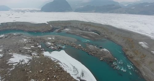 Aerial view of snowy mountains and icy river, Pakistan.
