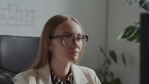 Focused Female Architect Working on Desktop Computer in Office