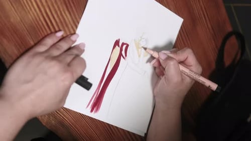 Woman Drawing Fashion Design on Paper with Marker