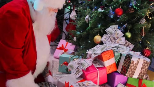 Santa Claus in festive mood scatters money around Xmas tree bringing good luck in New Year