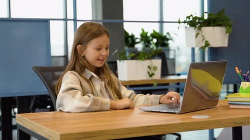 Girl Using Laptop at Desk Indoors