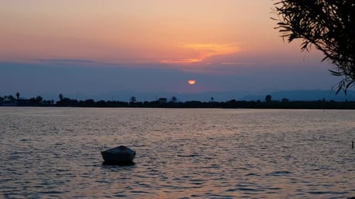 Wooden Boat on River Against Morning Sun
