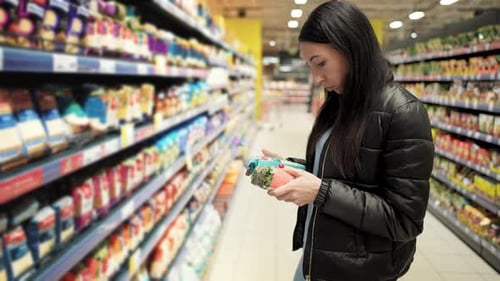 Woman Grocery Shopping in Supermarket Aisle