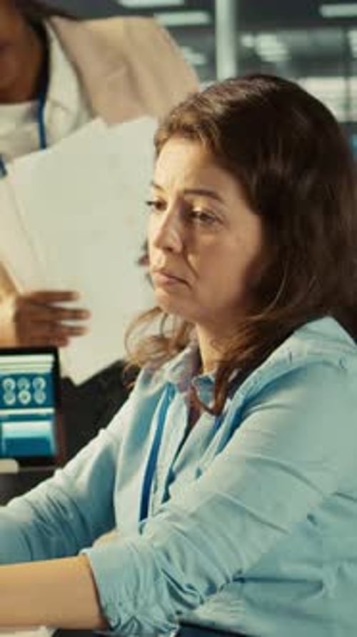 Vertical Video Stressed Worker in Office Sights Burdened By Too Many Documents to Review