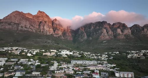 Drone flying high above camps bay in Cape Town South Africa - Many homes are located on a hillside -