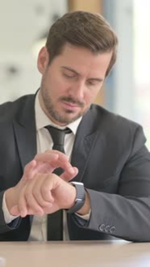 Businessman Using Smart watch at Work, vertical video