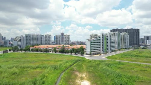 Aerial view of Camko city condominums buildings, highrise apartments and villas with green fields in