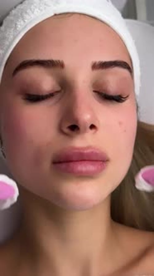 Young Adult Receiving Facial Cleansing Treatment