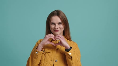 Closeup View of Attractive and Positive Woman Showing a Love Sign