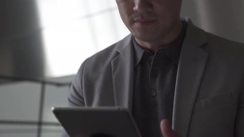 Man Using Tablet in Modern Office