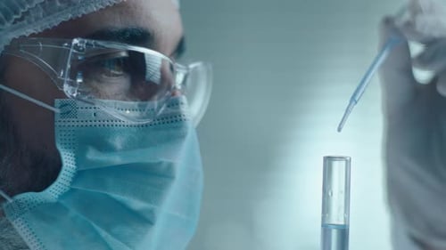 Healthcare Worker Uses Pipette on Sample in Lab