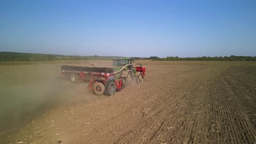 Tractor on the field seeding wheat