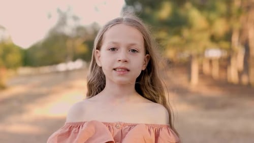 Happy Child Cute Blonde Girl Looks at Camera in Park Girl Smiles Happy Child in Park Summer Holidays