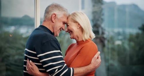Loving Senior Couple Embracing Indoors