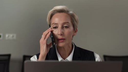 Woman Talking on Phone in Office Environment