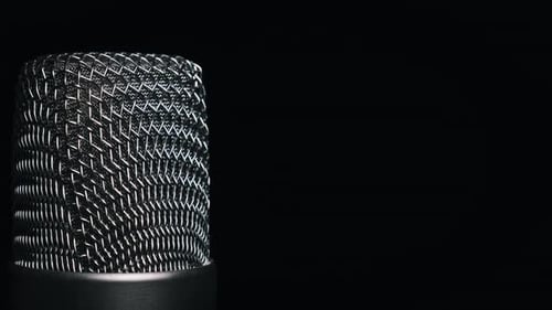 Studio Microphone Rotates on a Black Background CloseUp