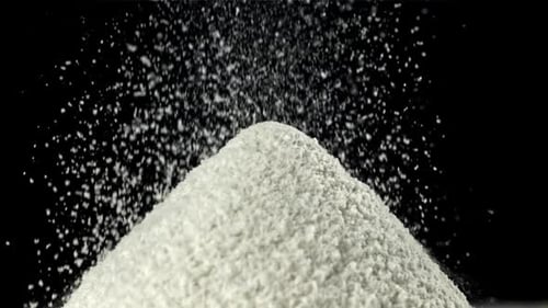 White Powder Piling Up Against Black Background