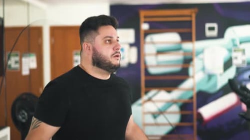 Close-up young man jumping rope to improve muscle strength and cardio routine in the gym